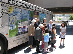 SamTrans Board members and the Art Takes a Bus Ride contest winners take a look at their art work displayed on the Art Bus. The bus will be used to provide regular service throughout the SamTrans service area for the next year.