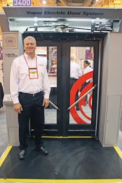 John P. Condon, vice president - sales for Vapor Bus International stands in front of the company&apos;s new electric actuator door system with Bluetooth capabilities.