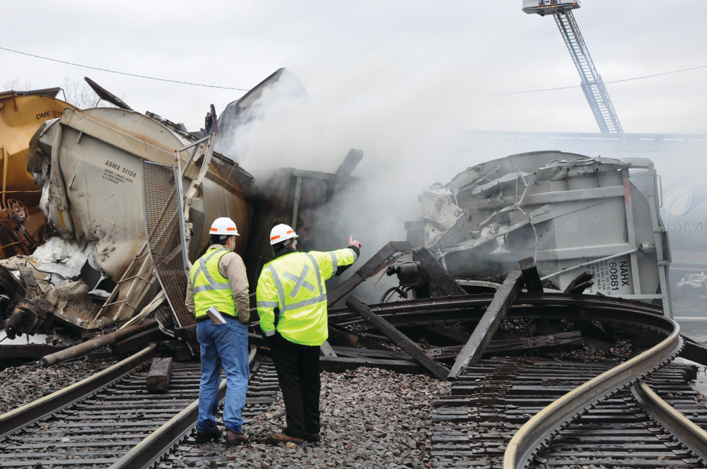 Workers survey the scene of devastation just hours after a CN freight train derailed near Bartlett, wrecking the intersection between the CN and Metra and trapping most of the Milwaukee West line fleet in its overnight storage yard.