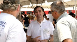 Talgo President and Chief Executive Officer Antonio Perez, center, talks with visitors at the firm&rsquo;s Milwaukee, Wis., facility during an open house Sunday, May 20.