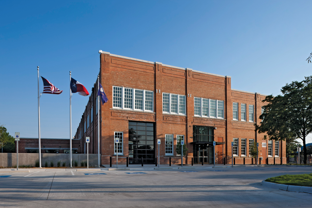 View of north fa&ccedil;ade after rehabilitation, including new windows, parapet cap, repaired masonry and landscaping.