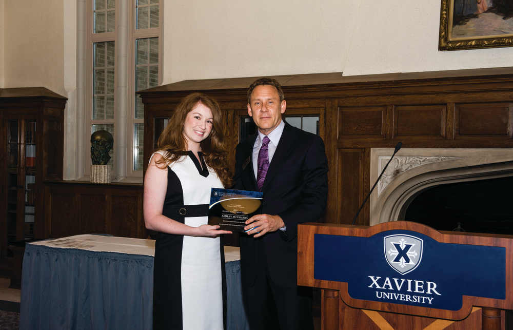 First Transit Director or Marketing Ashley McNamara was recognized as one of Xavier University's William College of Business Young Alums and presented the award by Dean Brian Till.