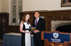 First Transit Director or Marketing Ashley McNamara was recognized as one of Xavier University&apos;s William College of Business Young Alums and presented the award by Dean Brian Till.