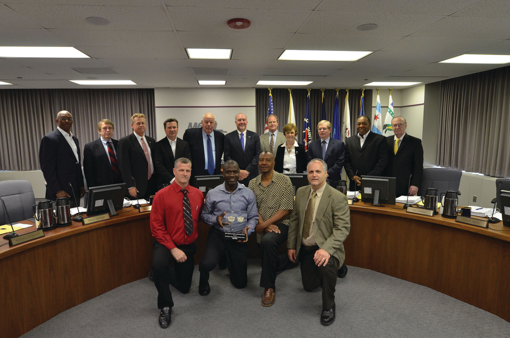 Back row are all Metra Board Members, from left to right, Stanley C. Rakestraw, William A. Widmer III, Don A. De Graff, Paul C. Darley, Jack Schaffer, Chairman Brad S. O&rsquo;Halloran, Mike McCoy, Arlene J. Mulder, Norman Carlson, Larry A, Huggins and Jack E. Partelow. Front row, from left to right, Steve East, carman and safety captain at 47th Street Diesel Shop; Shon George, superintendent, 47th Street; Lawrence Evans, machinist and safety captain at 47th Street; and Kevin McCann, director, Rock Island District Mechanical Department.