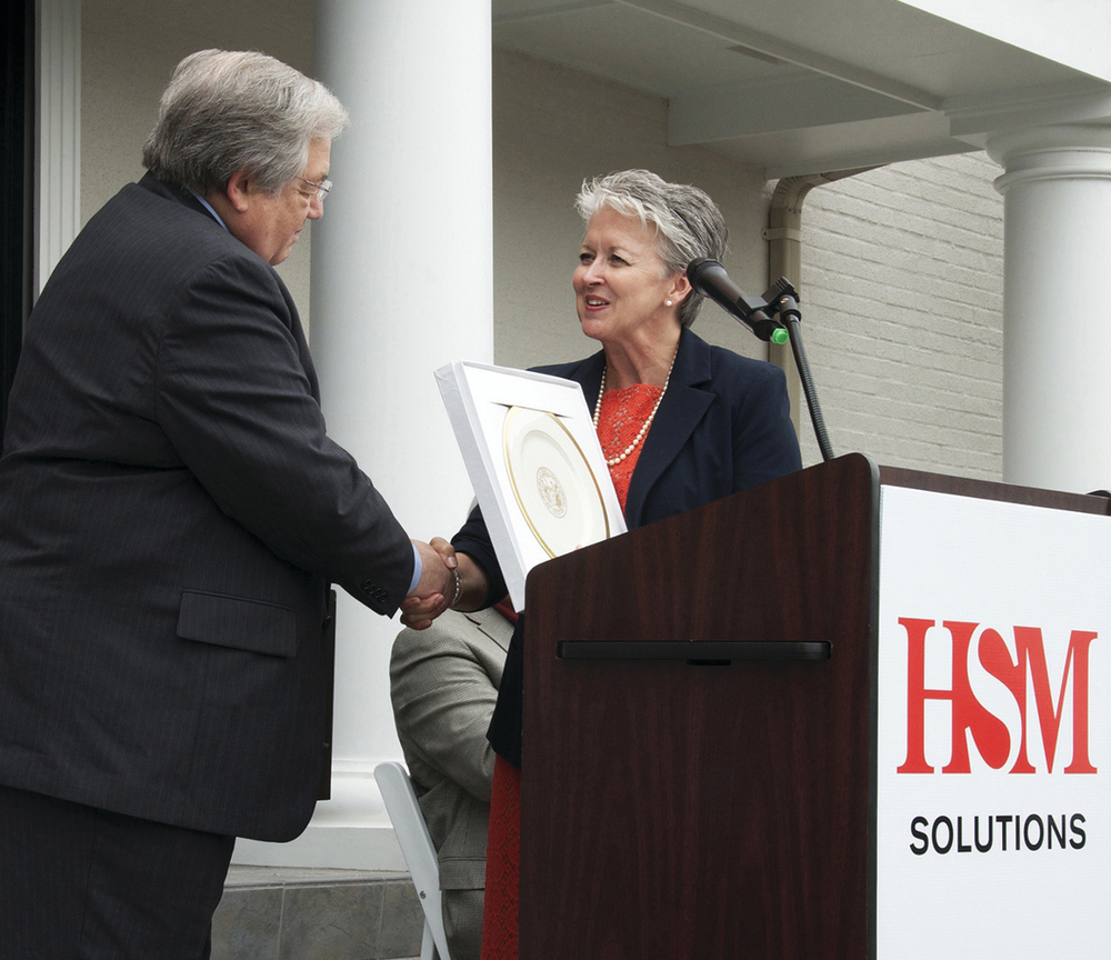 Dave Colburn, HSM president and CEO, accepts a gift from Sharon Decker, North Carolina Commerce Secretary, on behalf of North Carolina Governor Pat McCrory in recognition of HSM qualifying for a performance-based grant from the One North Carolina fund of up to $200,000. HSM plans to create 162 new jobs and invest more than $3.3 million over the next three years in Hickory and Conover, N.C