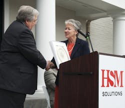 Dave Colburn, HSM president and CEO, accepts a gift from Sharon Decker, North Carolina Commerce Secretary, on behalf of North Carolina Governor Pat McCrory in recognition of HSM qualifying for a performance-based grant from the One North Carolina fund of up to $200,000. HSM plans to create 162 new jobs and invest more than $3.3 million over the next three years in Hickory and Conover, N.C