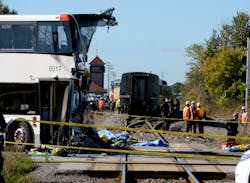 Emergency personnel look over the crash scene following a collision between a Via Rail train and a city bus at a crossing in Ottawa, Ontario, Wednesday, Sept. 18, 2013. An Ottawa Fire spokesman said there are “multiple fatalities” and a number of people injured from the bus. (AP Photo/The Canadian Press, Adrian Wyld) Emergency personnel look over the crash scene following a collision between a Via Rail train and a city bus at a crossing in Ottawa, Ontario, Wednesday, Sept. 18, 2013. An Ottawa Fire spokesman said there are “multiple fatalities” and a number of people injured from the bus. (AP Photo/The Canadian Press, Adrian Wyld)