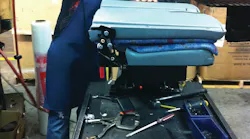 A Freedman Seating Co. employee assembles a portion of a seat.