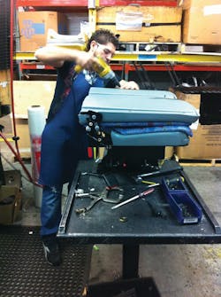A Freedman Seating Co. employee assembles a portion of a seat.