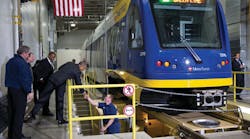President Barack Obama shakes hands with a worker as he and Transportation Secretary Anthony Foxx tour the Metro Transit Light Rail Operations and Maintenance Facility in St. Paul, Minn.