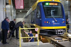 President Barack Obama shakes hands with a worker as he and Transportation Secretary Anthony Foxx tour the Metro Transit Light Rail Operations and Maintenance Facility in St. Paul, Minn.