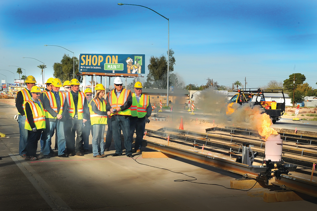 Mesa Mayor Scott Smith and East Valley Institute of Technology welding student, Sierra Jennings, ignite the first official rail weld for the Central Mesa light rail extension.