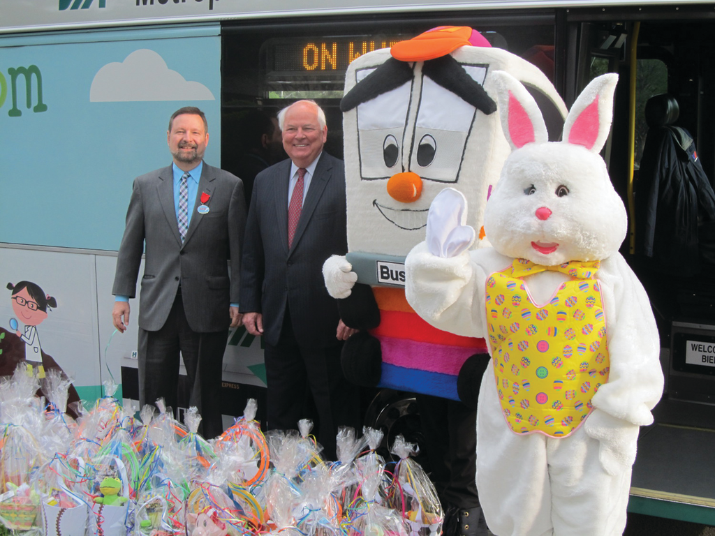 Via President/CEO Jeff Arndt is joined by Via Board member Steve Allison, Buster the Bus, and the Easter Bunny as they prepare to distribute Easter baskets donated by Via employees.