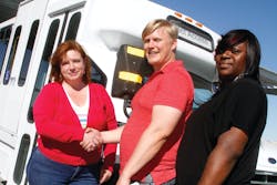 Midge Nicosia, VVCSC Executive Director, left, and Dyesha Sanders, VVCSC Program Manager, right, receive delivery of the VVTA-donated paratransit bus by VVTA Mobility Manager, Aaron Moore, center. The VVCSC New Freedom Program begins service to senior citizens and those with disabilities on Friday, April 25