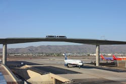 : The guideway crosses over Taxiway Romeo. The 340-foot bridge was designed with a vertical clearance height of more than 75 feet. : The guideway crosses over Taxiway Romeo. The 340-foot bridge was designed with a vertical clearance height of more than 75 feet.