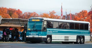 One of PRTC&rsquo;s MCI buses picks up passengers bound for the Pentagon.