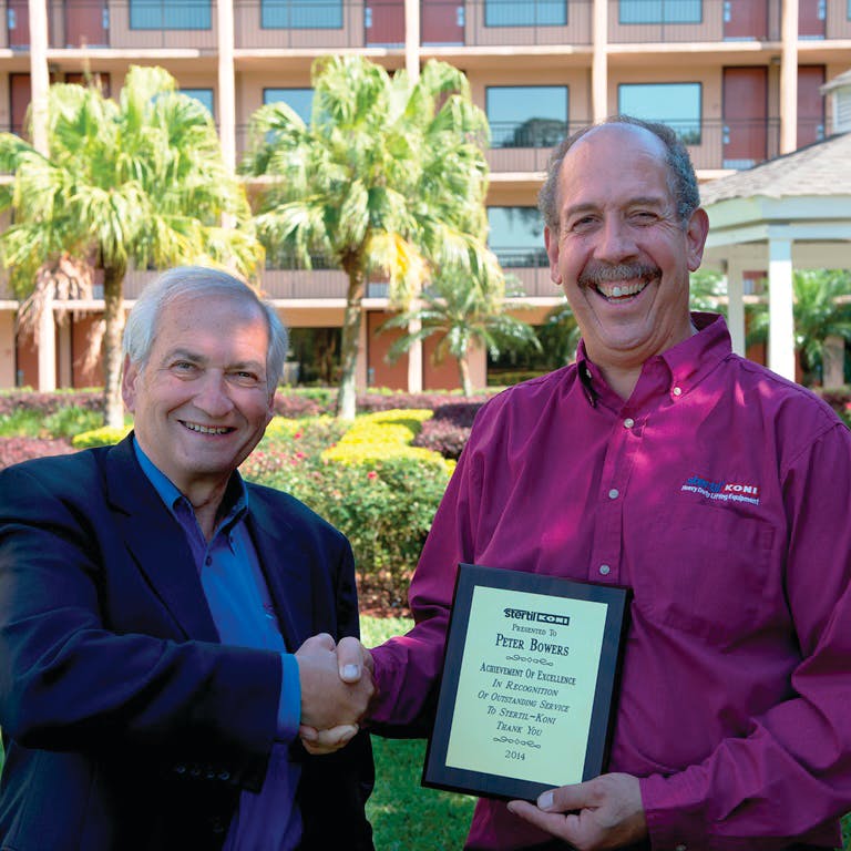 Peter Bowers, right, receives &ldquo;Achievement of Excellence&rdquo; award from Stertil-Koni President Jean DellAmore.