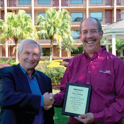 Peter Bowers, right, receives &ldquo;Achievement of Excellence&rdquo; award from Stertil-Koni President Jean DellAmore.