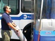 Bitimec Office Manager Christian Murillo demonstrates one of two 626-EZs installed at the 500-bus Eastchester depot of the New York Metropolitan Transportation Authority.