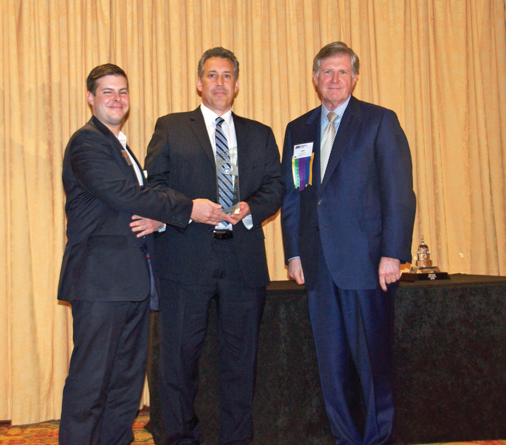 Accepting a Globe Award from the American Road & Transportation Builders Association (ARTBA) are, from left, Aaron Kurtz of HR+A Advisors, Inc. and Thomas C. Jost of Parsons Brinckerhoff. At right is Leo Vecellio, Jr. of Vecellio Group, Inc., representing ARTBA.