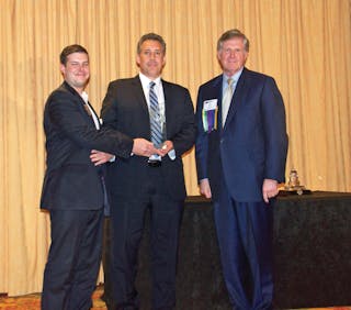 Accepting a Globe Award from the American Road &amp; Transportation Builders Association (ARTBA) are, from left, Aaron Kurtz of HR+A Advisors, Inc. and Thomas C. Jost of Parsons Brinckerhoff. At right is Leo Vecellio, Jr. of Vecellio Group, Inc., representing ARTBA.