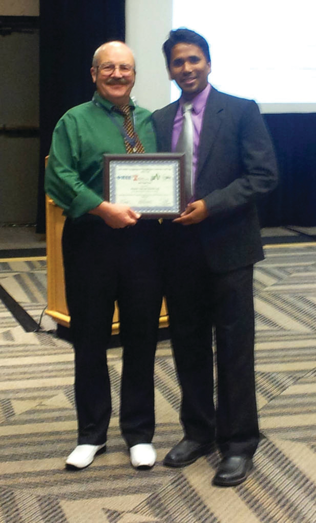 Senior Engineer-Power Conversion Specialist Alexander (Sasha) Isurin (left) accepts the Best Paper Award at the IEEE ITEC 2014 Conference.