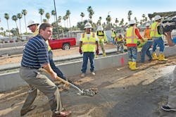 Mayor Greg Stanton assists with placement of the first track. Mayor Greg Stanton assists with placement of the first track.
