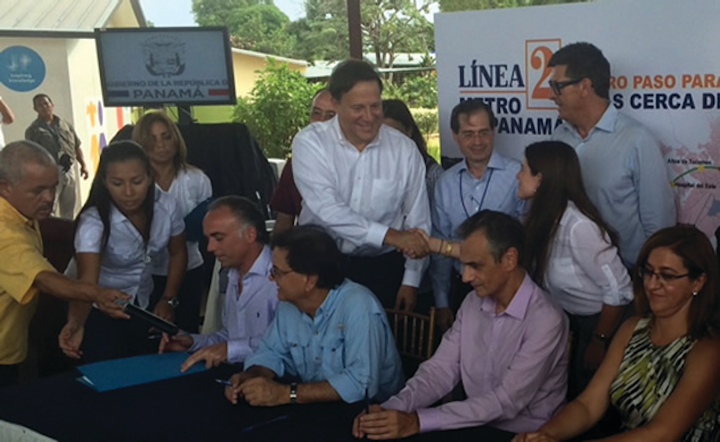 Standing: Panamanian President Juan Carlos Varela Rodriguez (standing white shirt) congratulates Sofia Berger, Louis Berger vice president in charge of Latin America and the Caribbean operations.