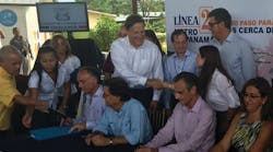 Standing: Panamanian President Juan Carlos Varela Rodriguez (standing white shirt) congratulates Sofia Berger, Louis Berger vice president in charge of Latin America and the Caribbean operations.