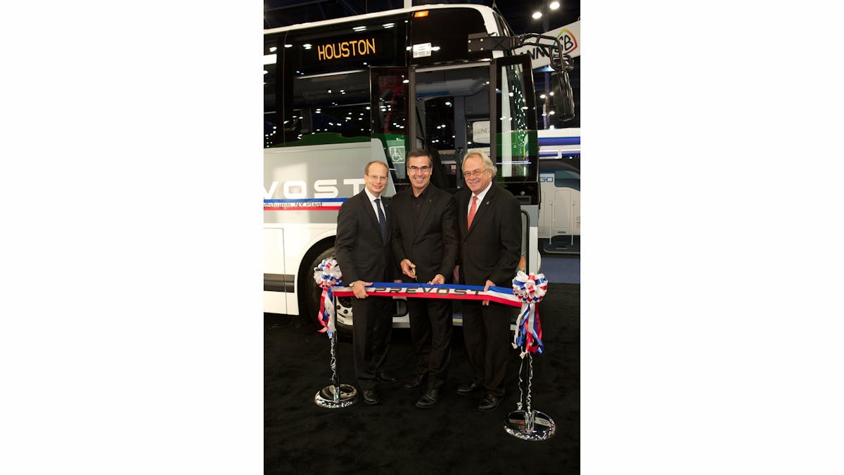 Prevost cuts the ribbon on its new commuter coach during the APTA Expo.