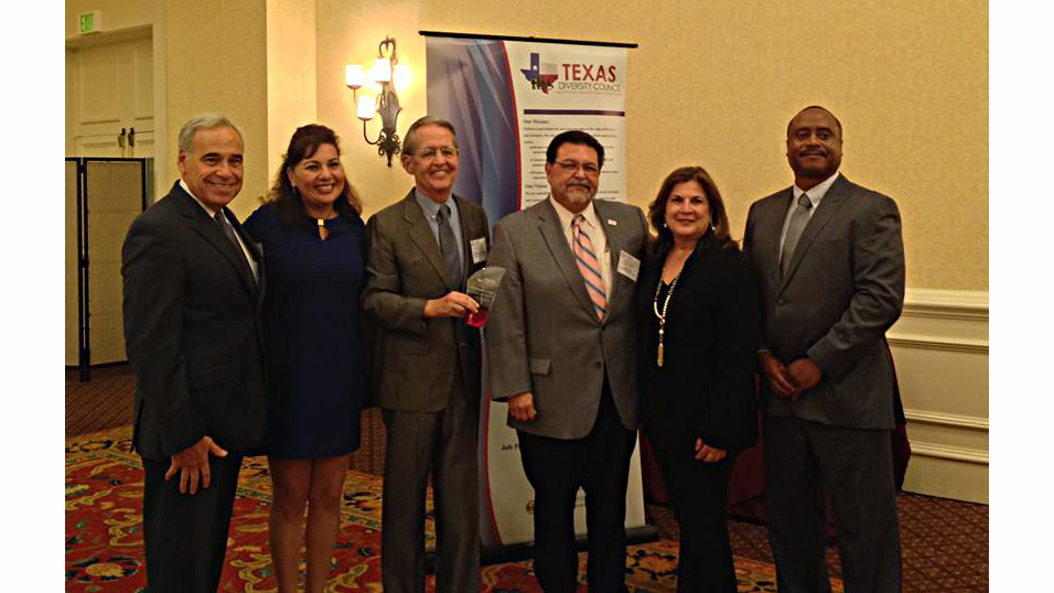 Via officials, led by VIA Board member Dr. Richard Gambitta and Via Board Chairman Alexander Brise&ntilde;o (3rd and 4th from left) accept the award from the Texas Diversity Council.