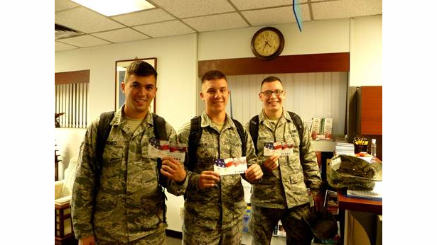 Airmen stationed at Osan Air Force Base, Korea with CPFS Calling Cards, courtesy Cell Phones for Soldiers
