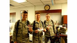 Airmen stationed at Osan Air Force Base, Korea with CPFS Calling Cards, courtesy Cell Phones for Soldiers