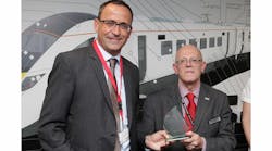Keith Jordan of Hitachi Rail Europe, right, presents Patrick Riederer of Huber+Suhner with the Hitachi Supplier Award.