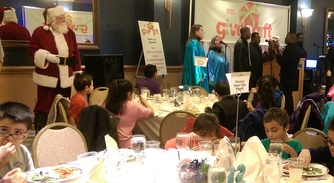 Children enjoy lunch before meeting with Santa.