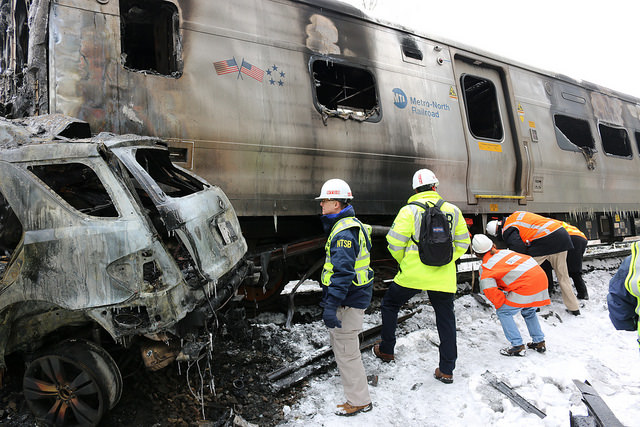 Member Sumwalt surveys vehicles involved in the Metro North train crash.