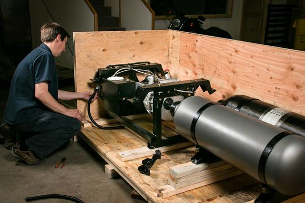 Lightning Hybrids engineer, Rodney Beardsley put finishing touches on a system that was shipped to the U.K in April.