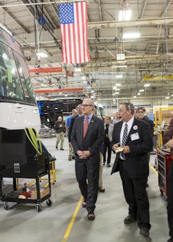 Rep. Kevin Cramer, R-N.D., left, learns about the MCI Commuter Coach assembly line from Ron Storey, Motor Coach Industries Pembina, N.D. plant manager.