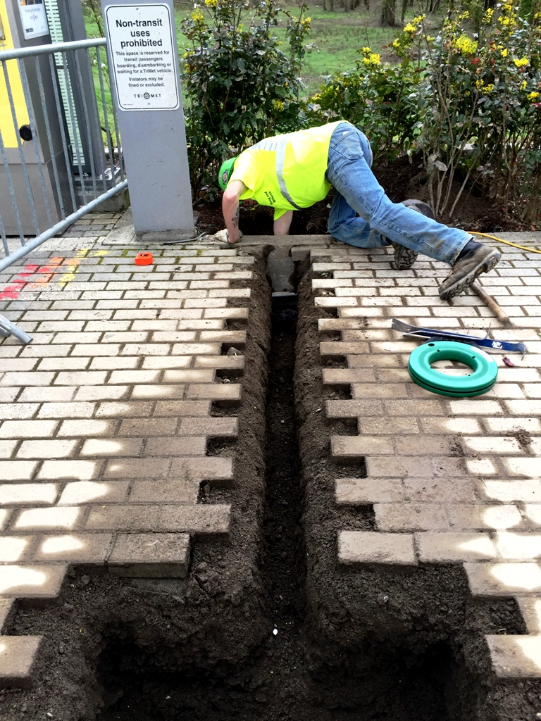 Crews are trenching and laying the conduit that will power e-fare readers.