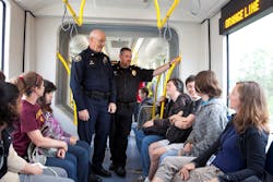 Transit Police Commander Mike Leloff, left, and Milwaukie Police Chief Steve Bartol, right, talk with students about the MAX Orange Line and safe behavior around trains. Transit Police Commander Mike Leloff, left, and Milwaukie Police Chief Steve Bartol, right, talk with students about the MAX Orange Line and safe behavior around trains.