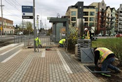 Crews work at the Civic Dr MAX Station, laying the conduit for e-fare card readers that will be installed in the future.