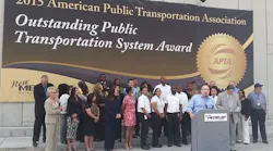 Metro Chairman, Gilbert Garcia, Metro President and CEO, Tom Lambert and Metro staff gather at Downtown Transit Center for big unveiling of APTA Award.