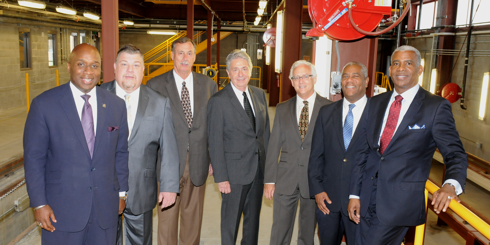 From left to right, SORTA Board Chair Jason Dunn and Vice Chair Ken Reed stand with Transdev's John Claflin (who will serve as General Manager of the Cincinnati Streetcar), Mike Setzer and Dick Alexander, along with Cincinnati Metro's Executive Vice President Darryl Haley and CEO & General Manager Dwight Ferrell inside the new Maintenance and Operations Facility of the Cincinnati Streetcar.