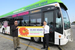 Jose Vega, Fuel Cell technician and trainer, and Roland Fecteau, assistant director of maintenance, both with the fuel cell program from its inception. Behind them, Fuel Cell Bus 7, whose fuel cell has clocked 20,000 hours of service.