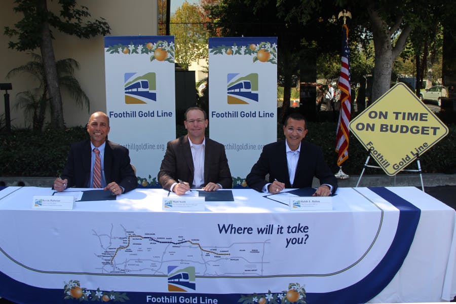 From left to right, Kevin Haboian, senior vice president, Parsons Transportation Group; Matt Scott, vice president and district manager, Kiewit Infrastructure West Co.; and Habib F. Balian, CEO of the Foothill Gold Line Construction Authority, sign the Substantial Completion Certificate for the Foothill Gold Line from Pasadena to Azusa.
