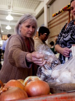 A shopper takes advantage of The Market opening to select fresh mushrooms. A shopper takes advantage of The Market opening to select fresh mushrooms.