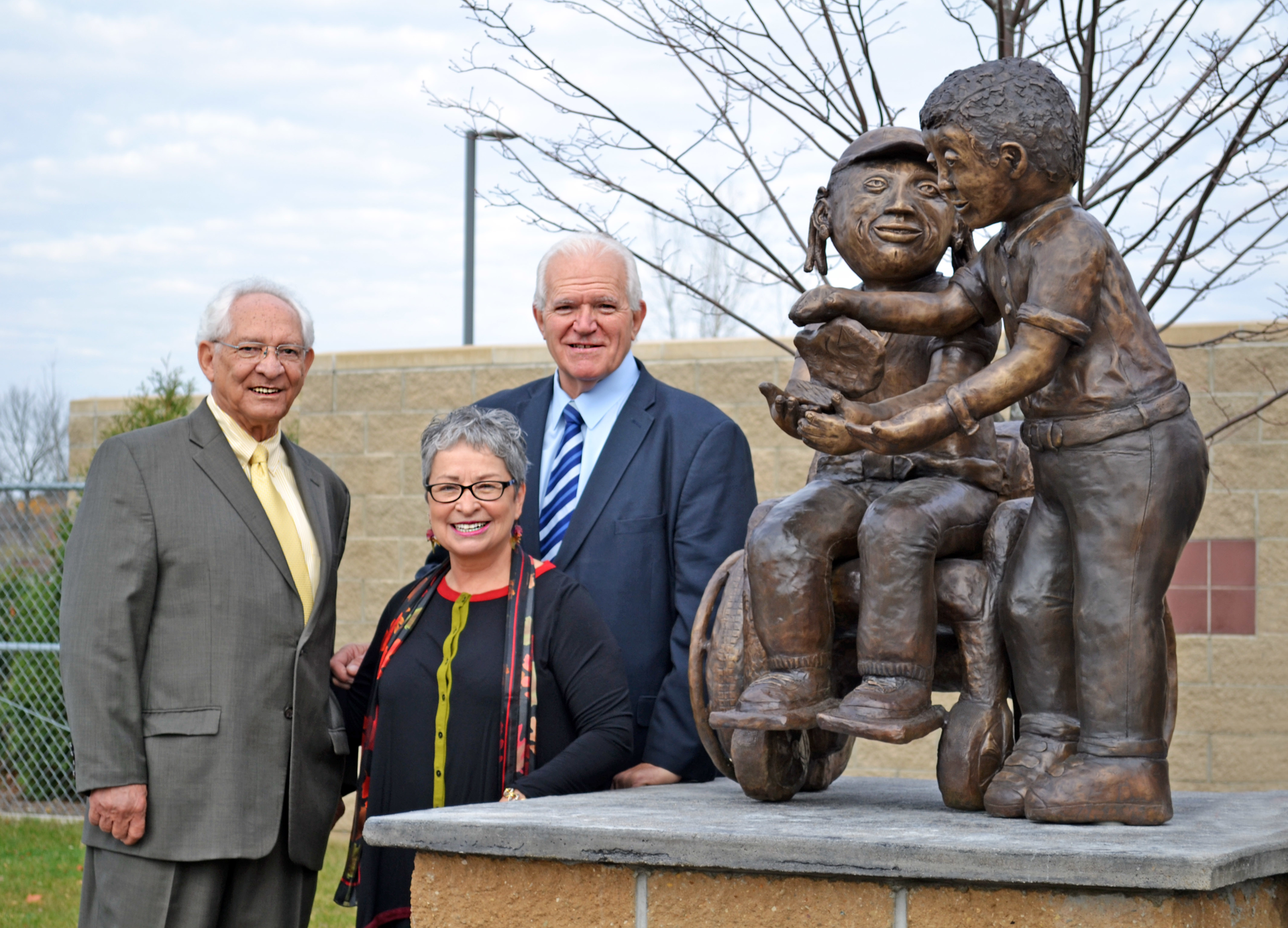 MTA board chairperson, Paul Newman, VSA Special Projects Coordinator, Randee Pieper (female in the middle) and Ed Benning, Flint MTA General Manager/CEO.