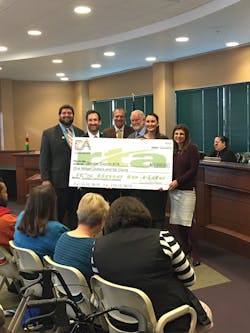 Commuter Advertising presents a check to the Greater Dayton Regional Transit Authority.