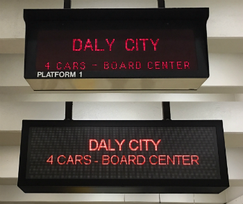 The new sign is larger one in back; old sign is at front.