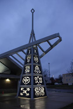 The Adinkra symbols and the words they represent are water-jet cut out of 20 aluminum panels, which are installed vertically along the four columns of the tower.